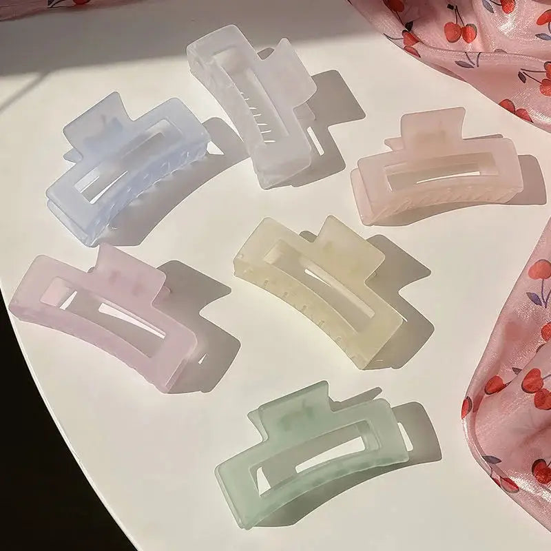 Assorted pastel jelly matte hairpins on table