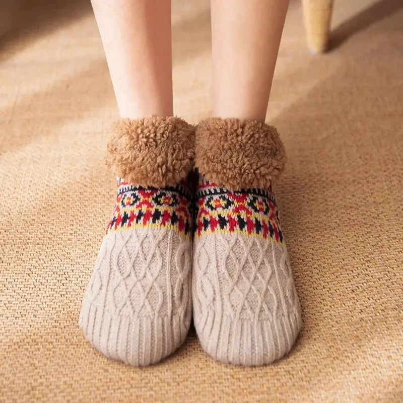 Beige fuzzy slipper socks worn on feet for warmth