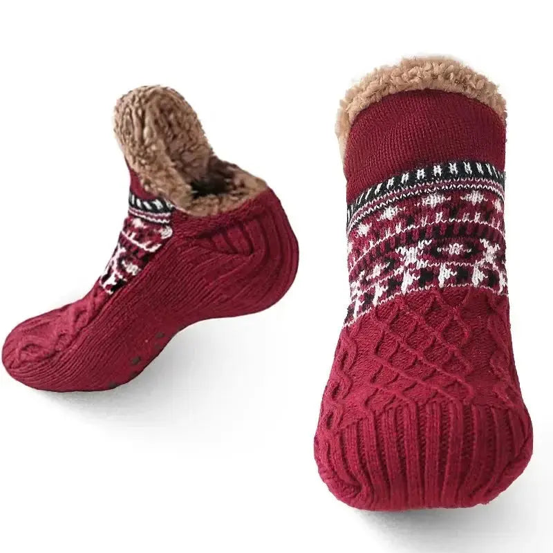 Red fuzzy slipper socks with grips and festive pattern