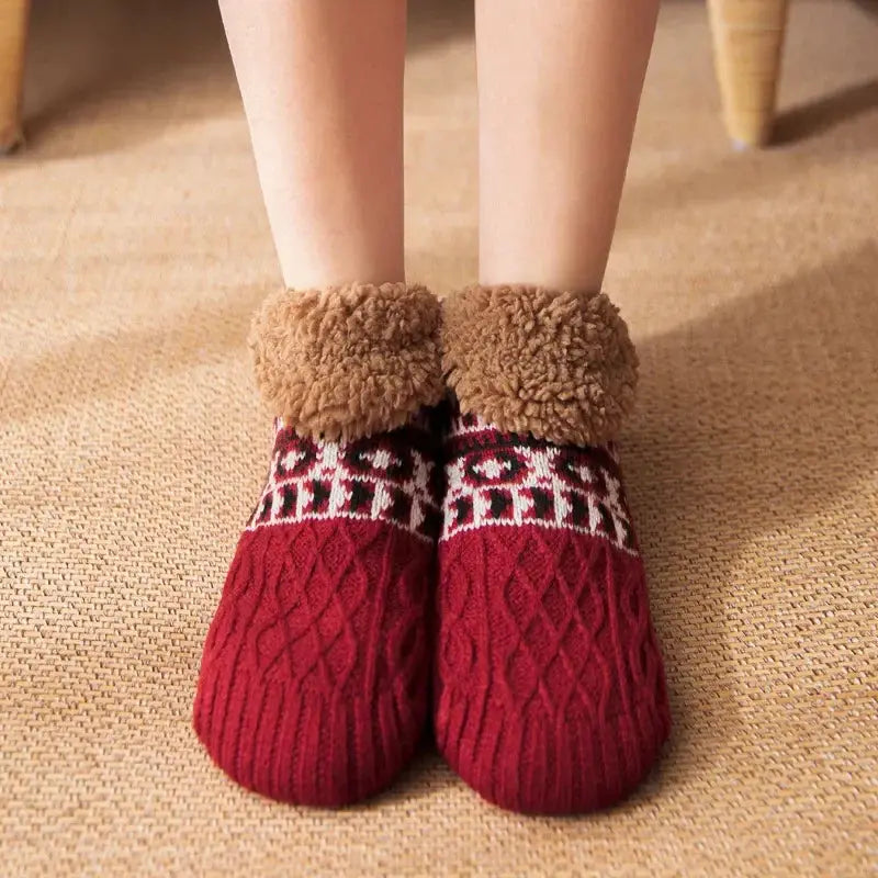 Red fuzzy slipper socks worn on feet for comfort